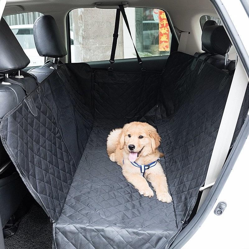 Golden retriever puppy resting on black waterproof pet car seat cover in SUV