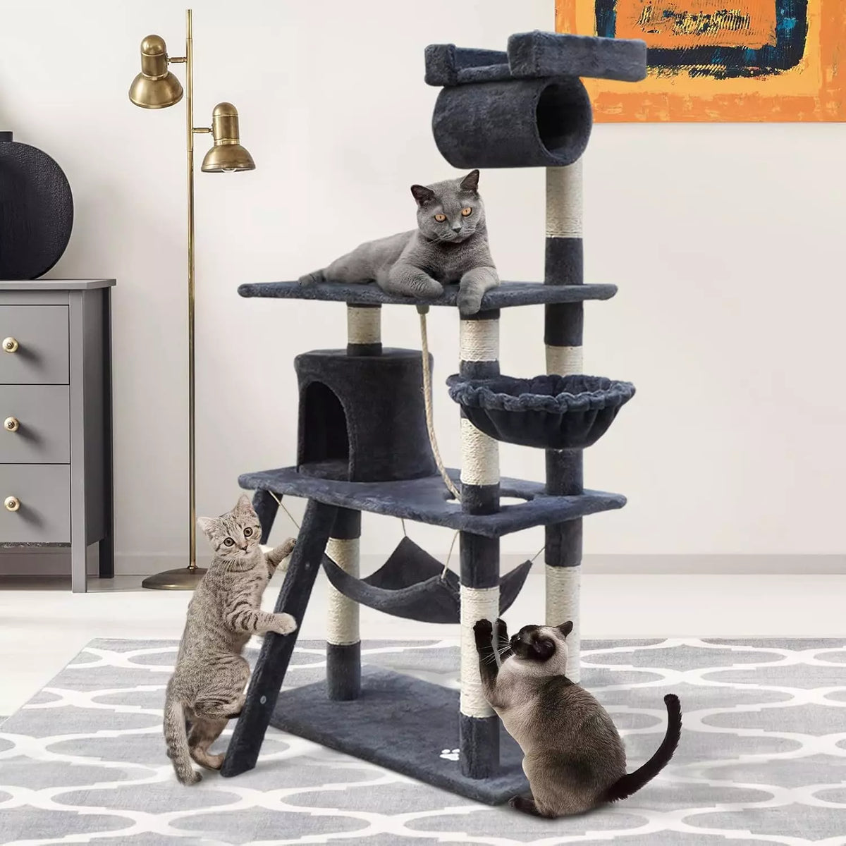 Dark grey cat scratching tree with three cats playing and lounging in a modern living room