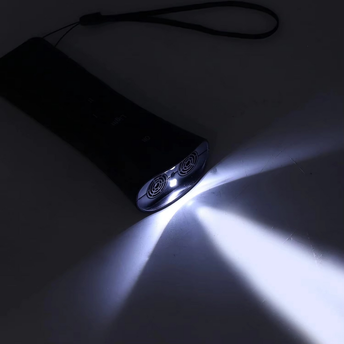 Ultrasonic barking device emitting bright white LED light beam from dual emitters in a darkened setting