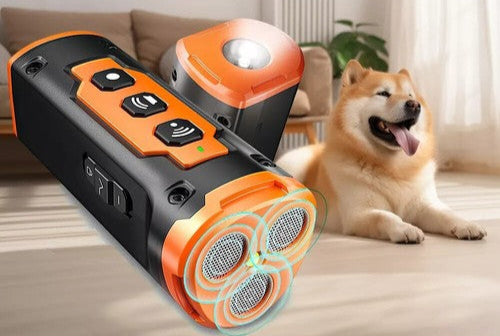 Orange Ultrasonic Dog Barking Deterrent Device held up towards a calm Shiba Inu dog sitting indoors