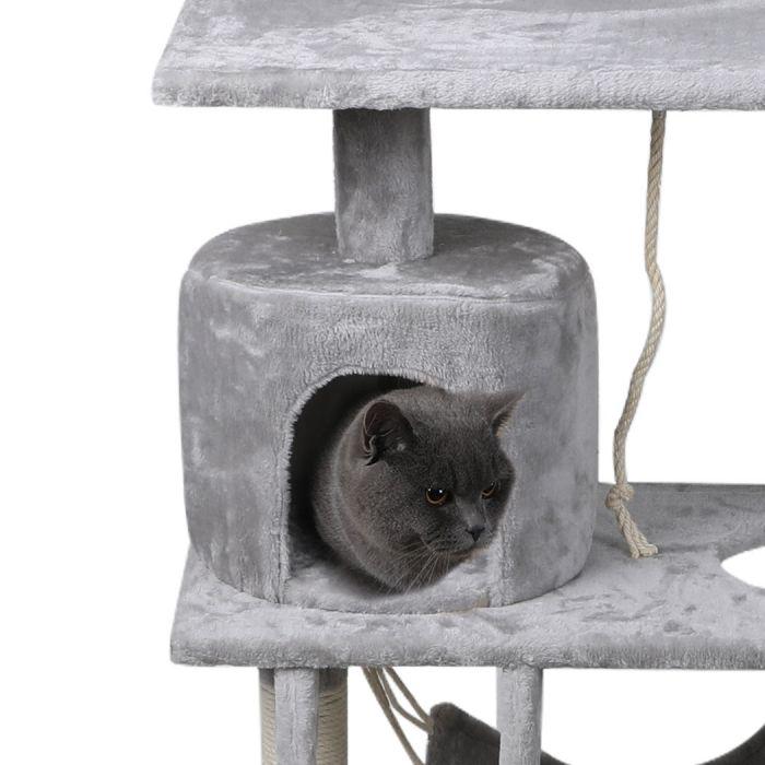 Grey British Shorthair cat resting inside the plush round hideaway cubby of a grey cat scratching tree